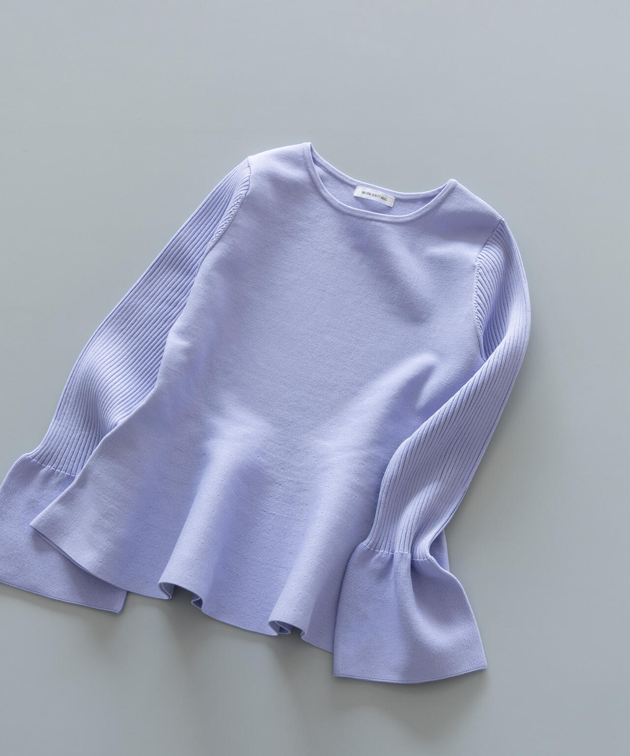 ベルスリーブペプラムニット